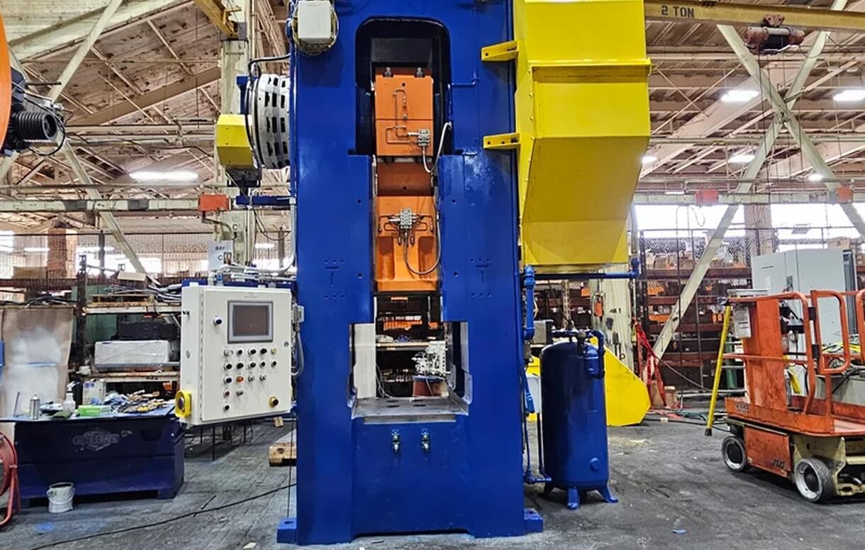 Ajax high-stroking rate mechanical forging press with blue frame and orange ram assembly on the shop floor
