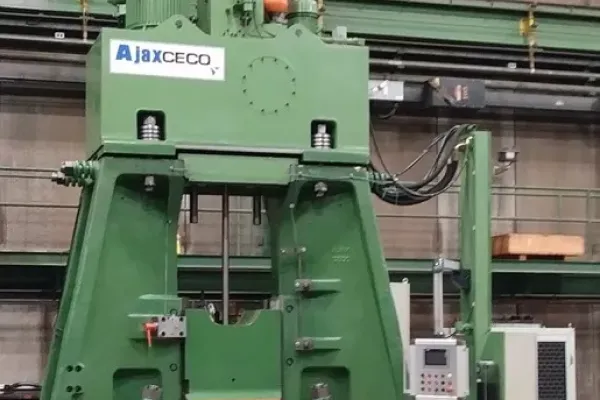 Ajax CECO hydraulic die forging hammer in a workshop.
