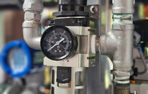 Air regulator and filter gauge on a pneumatic hammer in a forging shop managing plant air supply