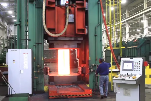 Ring forging press in operation with heated, glowing metal.